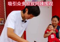 张国伟在亚运会场馆外摊煎饼 现场吸引了众多叔叔阿姨还有小朋友围观